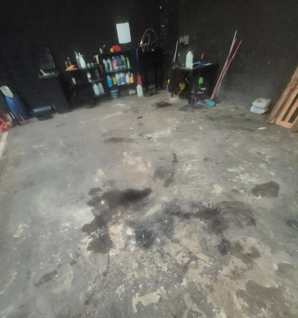 Piso de concreto com manchas escuras de óleo, no estado em que chegou